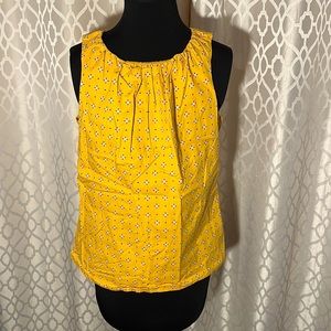 Worthington Size M women’s sleeveless top. Yellow with button on back.